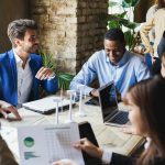 4 Strategies to Make Innovation a Core Skill in Your Company group of men and women sitting together and collaborating on a project.