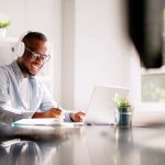 How to Build Connection, Growth, and Trust in Distributed Teams young worker on a laptop